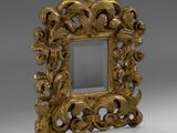 an ornate gold frame with a mirror on a grey background