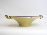yellow ceramic bowl with handles on a white background