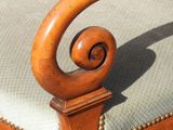 a wooden chair with a green cushion on it
