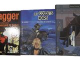 Trois livres sont alignés sur une surface blanche ; l'un représente un dragon et l'autre un démon.