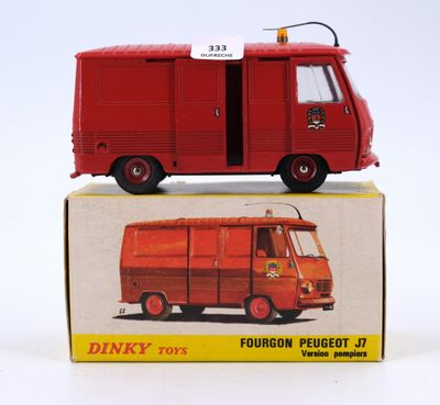 a red toy truck that is sitting on top of a box