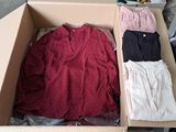 a cardboard box filled with clothes and a pair of pants