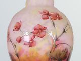 a vase that has a painting of flowers on it