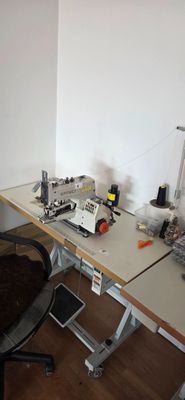 an image of a desk with a computer and sewing machine