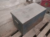 a metal box sitting on a pallet in the middle of the street