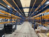 a large warehouse filled with lots of shelves and pallets