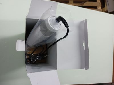 a white box with an umbrella inside of it on a table