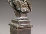 a bronze bust of a man with a beard on a pedestal