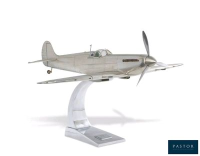 a silver model of a small plane on a stand