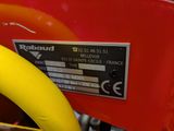 a close up of a red and yellow bike with a yellow handlebar