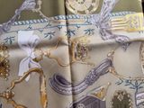 a close up of a scarf with a picture of a clock on it