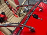 a close up of a red car with a steering wheel