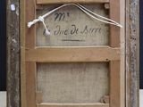 an old picture frame with a picture of a man and a woman on it