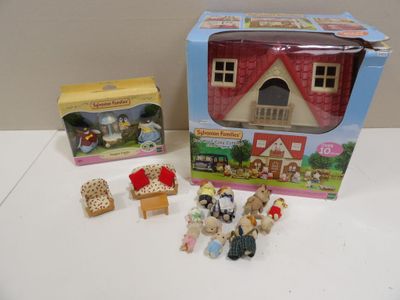 a box with a doll house and other toys on the table