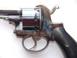 a gun that is sitting on a white surface