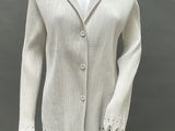 an image of a mannequin wearing a white sweater and black leggings