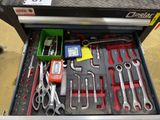 many tools in a tool box on the floor