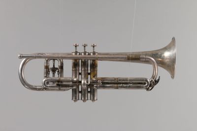 a silver trumpet that is hanging from the ceiling