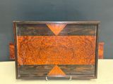 an old wooden box with a brown and orange design on it