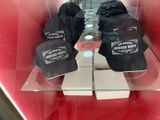 three hats that are on display in a glass case