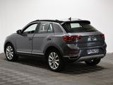 the rear end of a grey volkswagen suv parked in a room