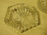 two glass ashtrays sitting on a table