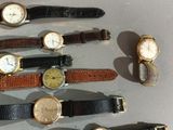 a lot of watches that are sitting on a table