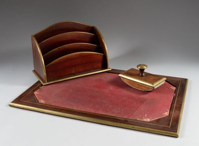 a desk with a pen and a paper holder on it