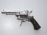 an old revolver with a wooden handle on a white surface
