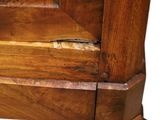 a close up view of a wooden bed with a wooden headboard