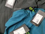two tags on the back of a jacket with a name tag