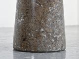 a vase with a flower in it on a table