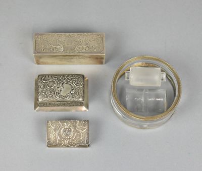 three pieces of silver and glass are sitting on a white surface