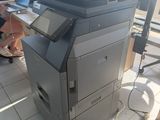 a man sitting at a desk with a printer in front of him