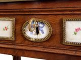 a close up of a wooden desk with flowers on it