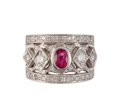 a close up of a diamond and ruby ring on a white background