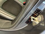 a close up of a car door handle with a ruler on it