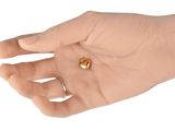 a person holding a gold ring in their hand