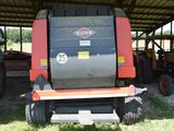 a tractor that is parked under a shelter