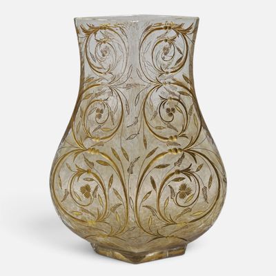a glass vase that is sitting on a white surface