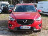 a red mazda cx - 5 parked in a parking lot