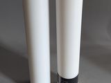 two white vases sitting next to each other on a table