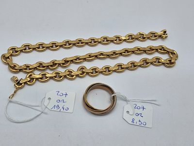a close up of a gold chain with a ring on it
