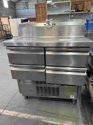several stainless steel ovens stacked on top of each other in a warehouse