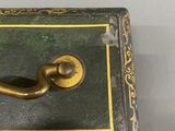 a black box with a gold handle on a table