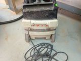 a machine that is sitting on the floor next to a pile of wires