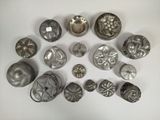 a lot of metal knobs on a white surface