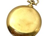 une montre de poche en or sur fond blanc