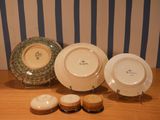 three plates and two cupcakes sitting on a table