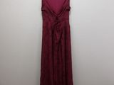 maroon dress hanging on a hanger in a white room